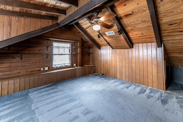 bonus room featuring wood walls, visible vents, a ceiling fan, wooden ceiling, and carpet floors