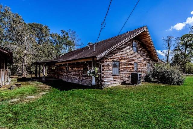 rear view of property with a yard and central air condition unit