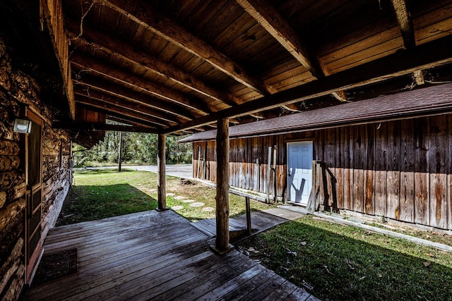 wooden deck featuring a lawn