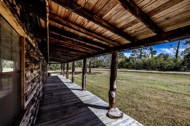 wooden deck featuring a yard