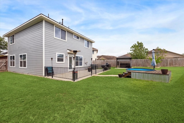 back of property featuring a patio, a fenced backyard, and a yard