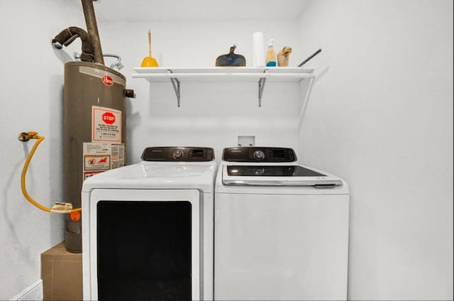 washroom featuring washer and dryer, water heater, and laundry area