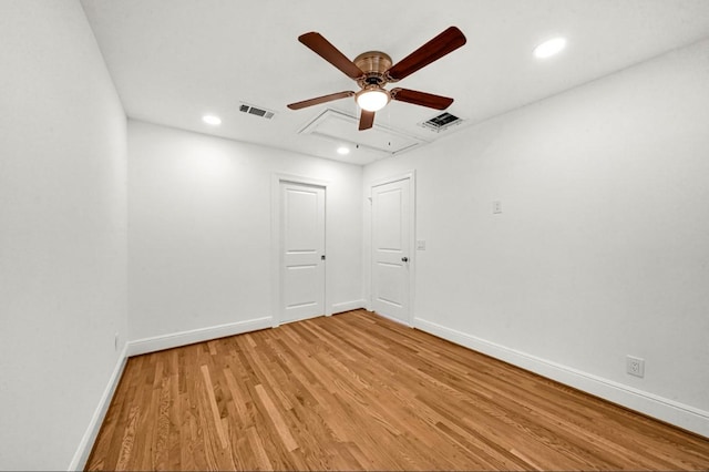 unfurnished room featuring light wood finished floors, baseboards, a ceiling fan, and visible vents