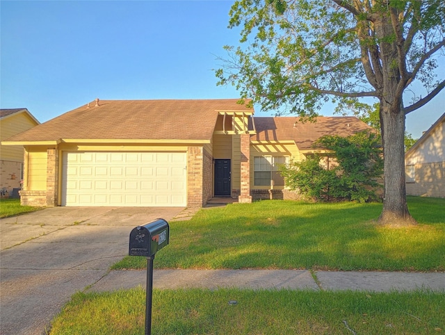 view of front facade with a garage, driveway, a front lawn, and brick siding
