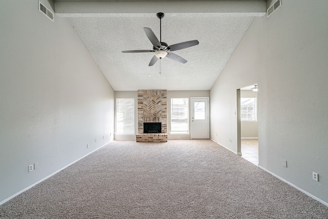 unfurnished living room featuring carpet floors, ceiling fan, visible vents, and a brick fireplace