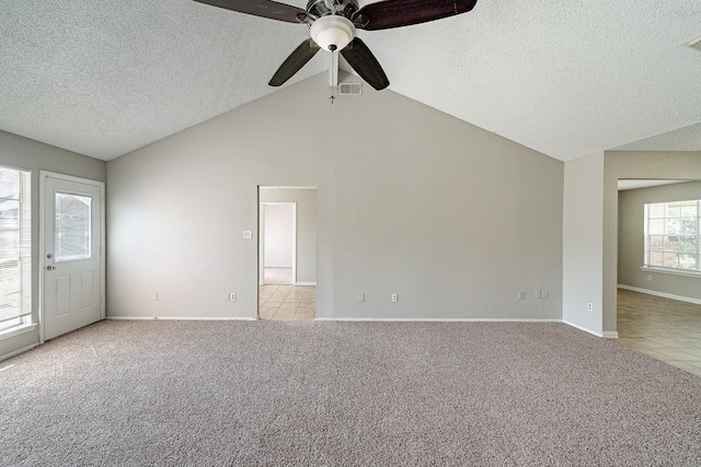 unfurnished living room featuring ceiling fan, a textured ceiling, baseboards, vaulted ceiling with beams, and light carpet
