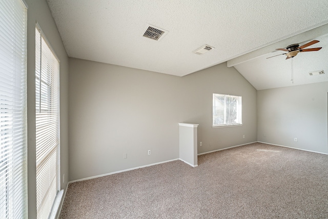 carpeted spare room with visible vents, ceiling fan, and a wealth of natural light
