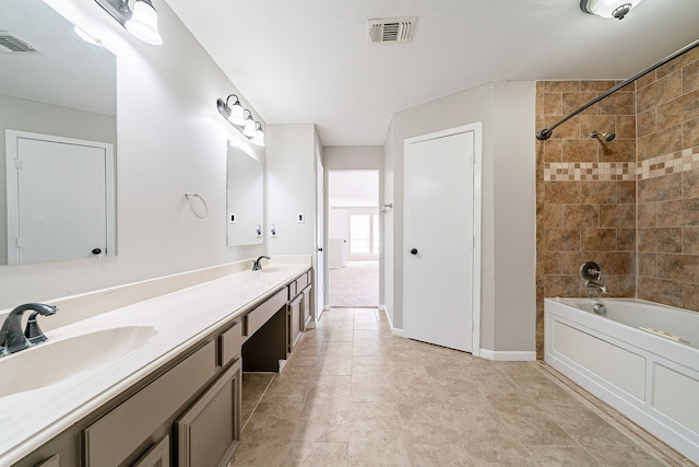 full bathroom with visible vents, a sink, and  shower combination