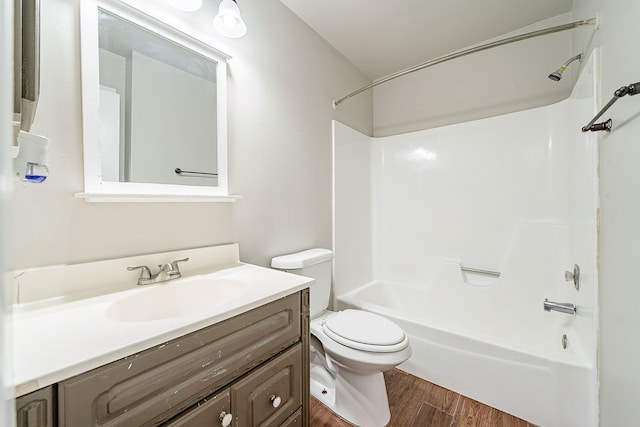 full bathroom featuring vanity, toilet, wood finished floors, and shower / washtub combination