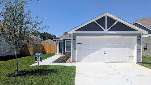 single story home featuring an attached garage, driveway, fence, and a front lawn