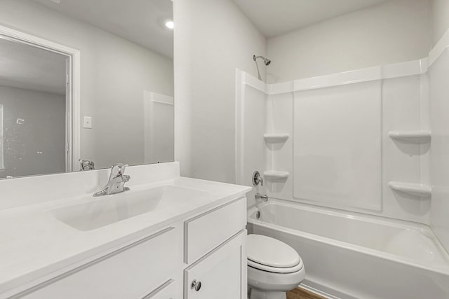 bathroom with shower / bathing tub combination, toilet, and vanity
