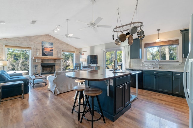 1222 Harts Creek Rd, Trinity, TX 75862 - kitchen featuring open floor plan, vaulted ceiling, and a sink