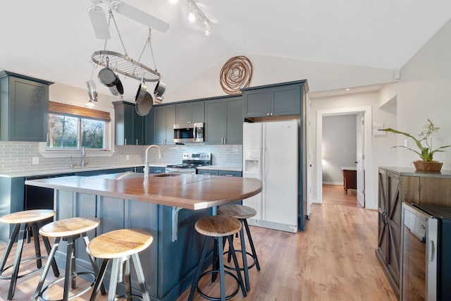 1222 Harts Creek Rd, Trinity, TX 75862 - kitchen with lofted ceiling, wooden counters, stainless steel appliances, wine cooler, and a sink
