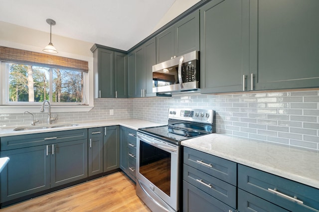 1222 Harts Creek Rd, Trinity, TX 75862 - kitchen with light countertops, hanging light fixtures, appliances with stainless steel finishes, and a sink