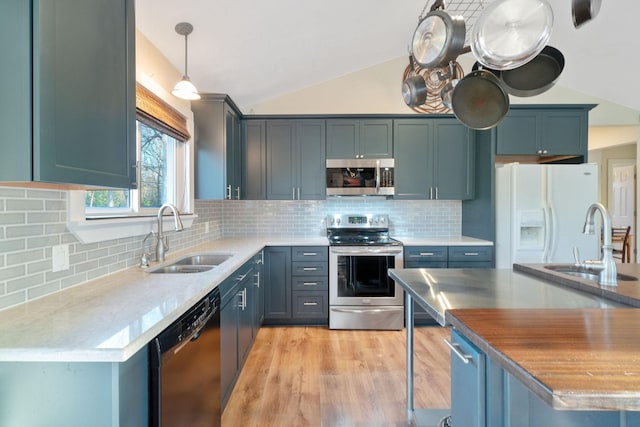 1222 Harts Creek Rd, Trinity, TX 75862 - kitchen featuring lofted ceiling, stainless steel appliances, a sink, and light wood-style floors