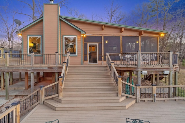 1222 Harts Creek Rd, Trinity, TX 75862 - back of house with a wooden deck, a chimney, a sunroom, and stairs