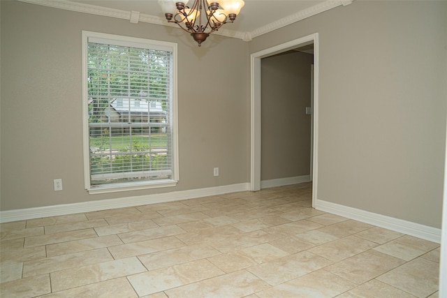 spare room featuring crown molding, baseboards, and a notable chandelier