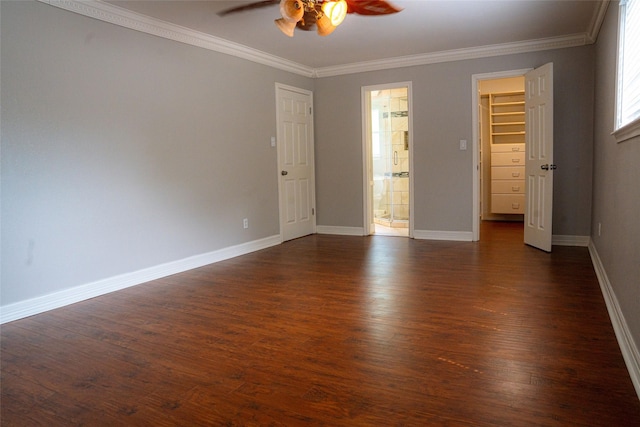 unfurnished room with a ceiling fan, baseboards, ornamental molding, and dark wood-style flooring