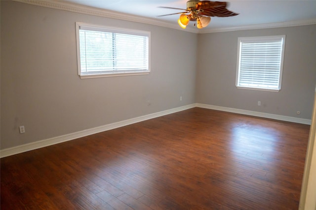 spare room with baseboards, a ceiling fan, dark wood-style floors, and ornamental molding