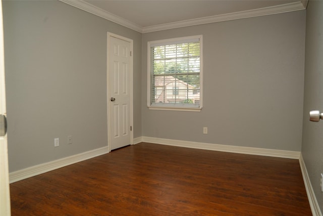 empty room with baseboards, ornamental molding, and dark wood-style flooring