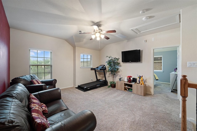 living room featuring attic access, carpet flooring, a ceiling fan, and baseboards