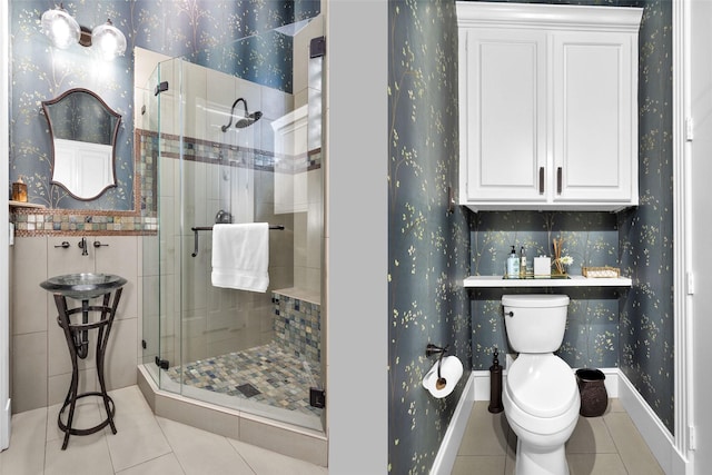 full bath with toilet, tile patterned floors, wallpapered walls, and a stall shower