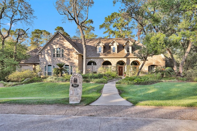 view of front of home with stone siding and a front yard