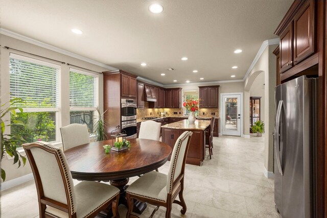 24636 Hosford Meadows Dr, Porter, TX 77365 - dining space featuring arched walkways, baseboards, recessed lighting, and crown molding