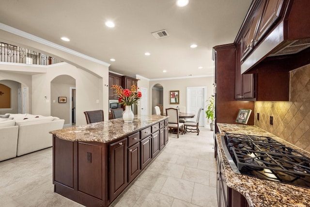 24636 Hosford Meadows Dr, Porter, TX 77365 - kitchen featuring recessed lighting, exhaust hood, visible vents, ornamental molding, and arched walkways