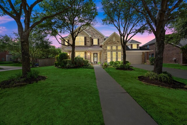 24636 Hosford Meadows Dr, Porter, TX 77365 - traditional home featuring a garage, concrete driveway, stone siding, fence, and a front yard