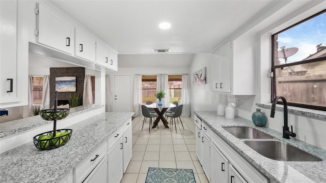 9831 Sagequeen Dr, Houston, TX 77089 - kitchen with white cabinets, visible vents, a sink, and light tile patterned floors
