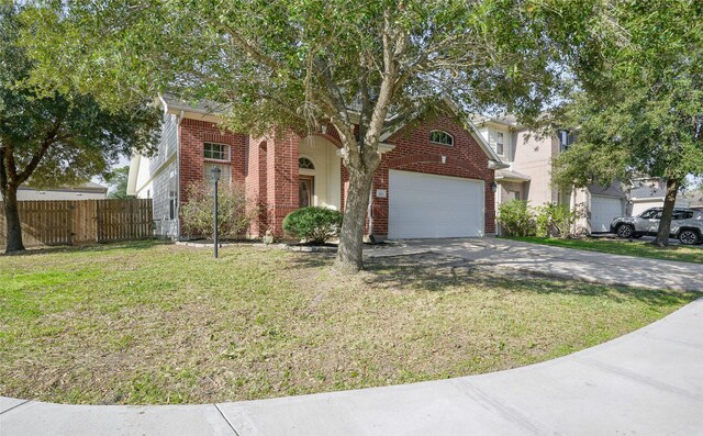 203 Annatto Ln, Crosby, TX 77532 - obstructed view of property with brick siding, an attached garage, and driveway