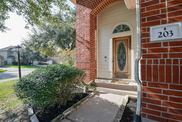 203 Annatto Ln, Crosby, TX 77532 - doorway to property with brick siding