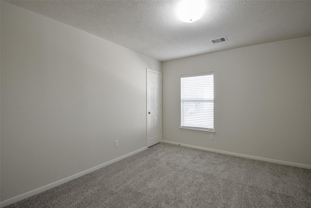 203 Annatto Ln, Crosby, TX 77532 - unfurnished room featuring light carpet, baseboards, and a textured ceiling
