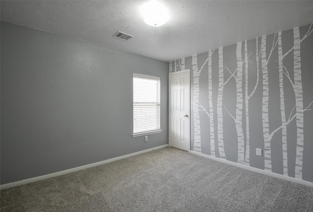 203 Annatto Ln, Crosby, TX 77532 - unfurnished bedroom with a textured ceiling, carpet floors, and baseboards