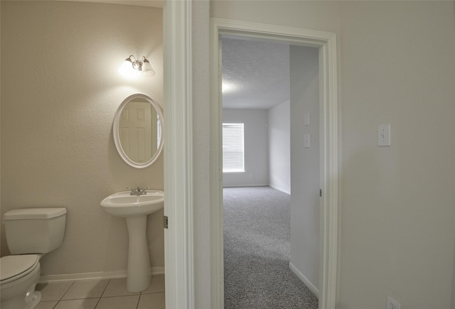 203 Annatto Ln, Crosby, TX 77532 - half bath with toilet, baseboards, and a sink