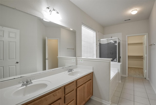 203 Annatto Ln, Crosby, TX 77532 - full bath featuring a stall shower, tile patterned flooring, a garden tub, double vanity, and a spacious closet