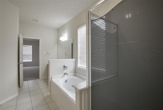 203 Annatto Ln, Crosby, TX 77532 - bathroom featuring tile patterned flooring, a garden tub, a shower stall, and baseboards
