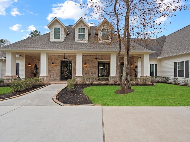 10539 Crestwater Cir, Magnolia, TX 77354 - view of front of property featuring brick siding, ceiling fan, a front yard, and roof with shingles
