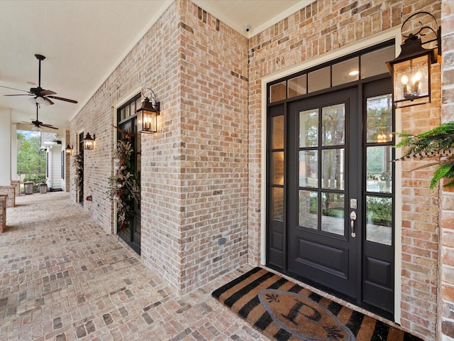 10539 Crestwater Cir, Magnolia, TX 77354 - doorway to property featuring french doors, brick siding, ceiling fan, and covered porch