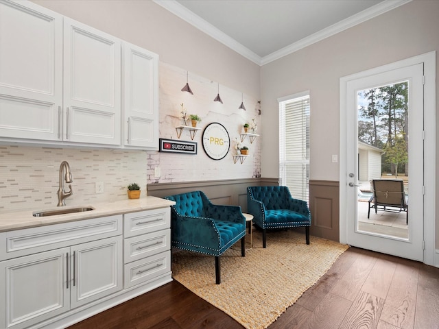 10539 Crestwater Cir, Magnolia, TX 77354 - sitting room with dark wood-style flooring, crown molding, and a wainscoted wall
