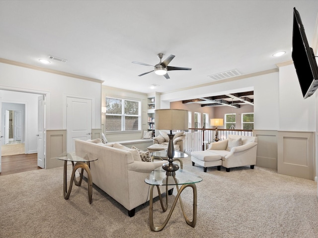 10539 Crestwater Cir, Magnolia, TX 77354 - living area with carpet floors, a ceiling fan, ornamental molding, a wainscoted wall, and a decorative wall
