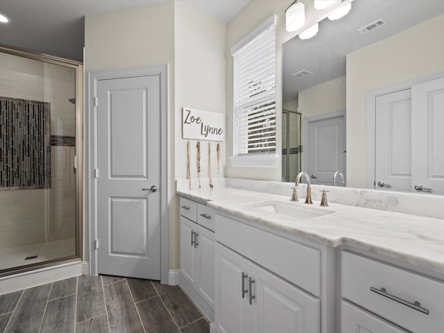10539 Crestwater Cir, Magnolia, TX 77354 - full bathroom with a shower stall, vanity, and wood finished floors