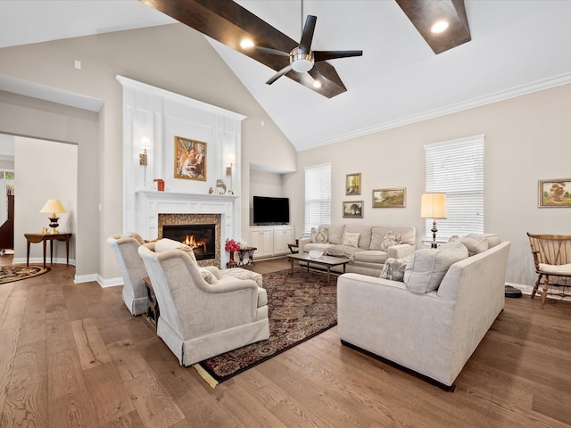 10539 Crestwater Cir, Magnolia, TX 77354 - living area featuring high vaulted ceiling, a ceiling fan, a glass covered fireplace, wood finished floors, and baseboards