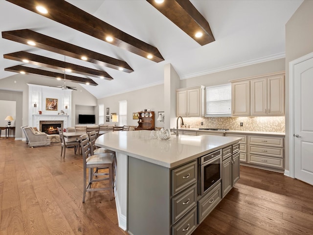 10539 Crestwater Cir, Magnolia, TX 77354 - kitchen with cream cabinets, gray cabinetry, built in microwave, light countertops, and decorative backsplash
