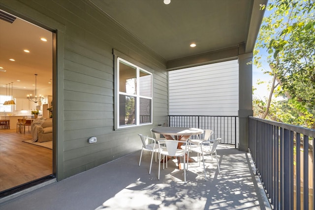 balcony featuring visible vents and outdoor dining area