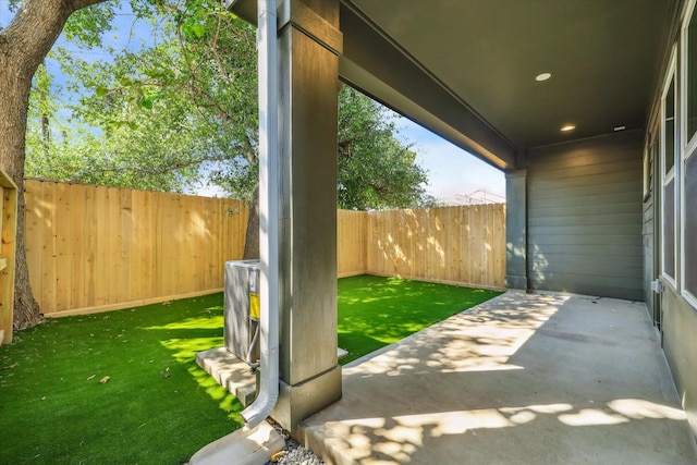 view of patio with a fenced backyard and central AC