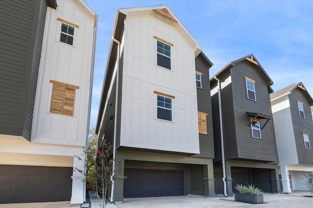 view of front facade featuring concrete driveway, board and batten siding, and a garage