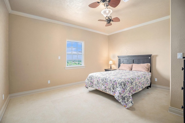 carpeted bedroom with ceiling fan, baseboards, and ornamental molding