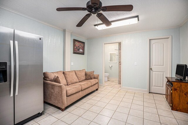 living area featuring a ceiling fan, light tile patterned floors, and crown molding